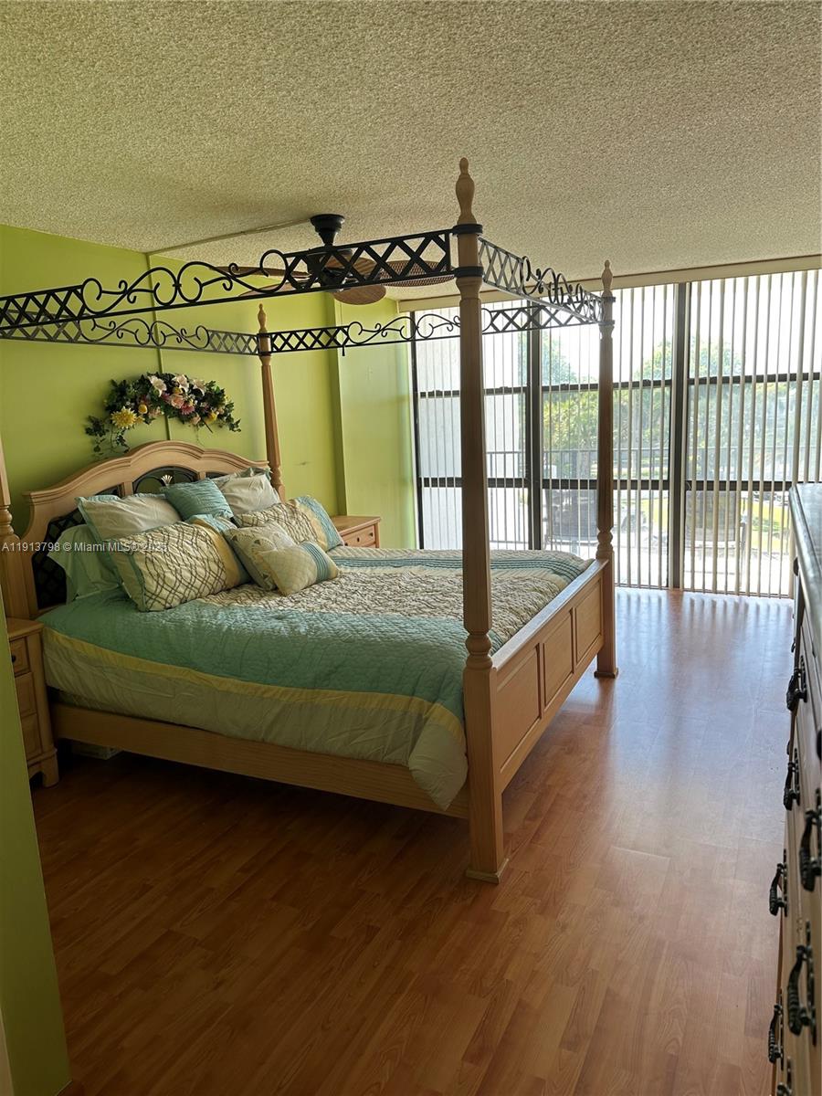 1000 Parkview Drive, Unit 325 Hallandale Beach, FL 33009 - Photo 6 of 7 a bedroom with a bed and wooden floor