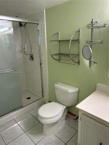 a bathroom with a toilet a sink and shower