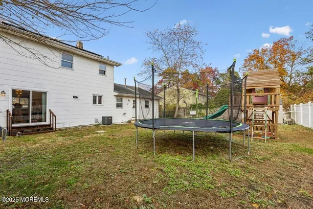 a view of a swimming pool with a bench and some trees