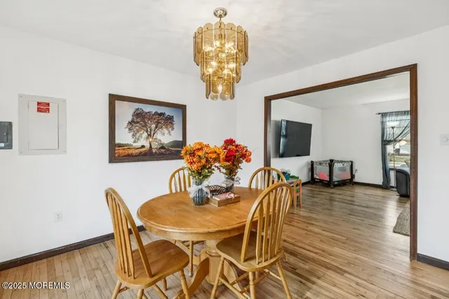 a dining room with furniture and wooden floor