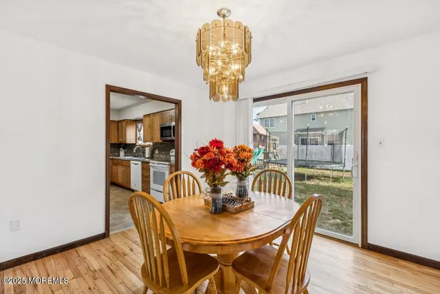 a view of a dining room with furniture wooden floor and chandelier