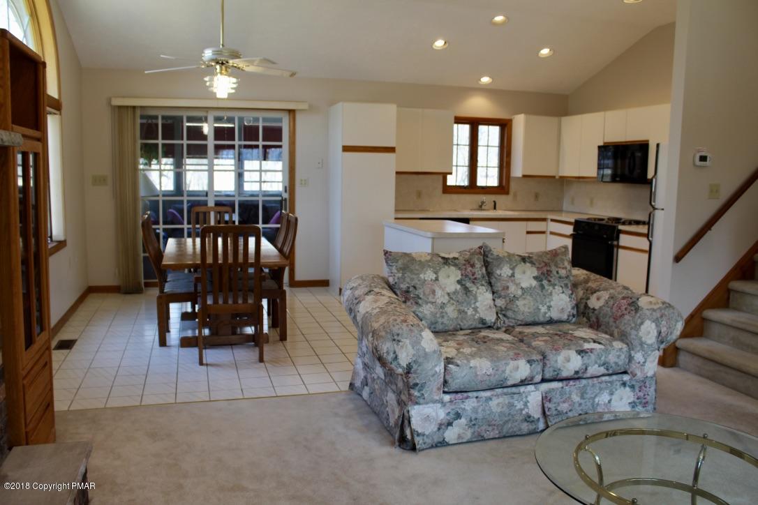 108 Gold Finch Road Bushkill, PA 18324 - Photo 11 of 32 a living room with furniture and a dining table with kitchen view