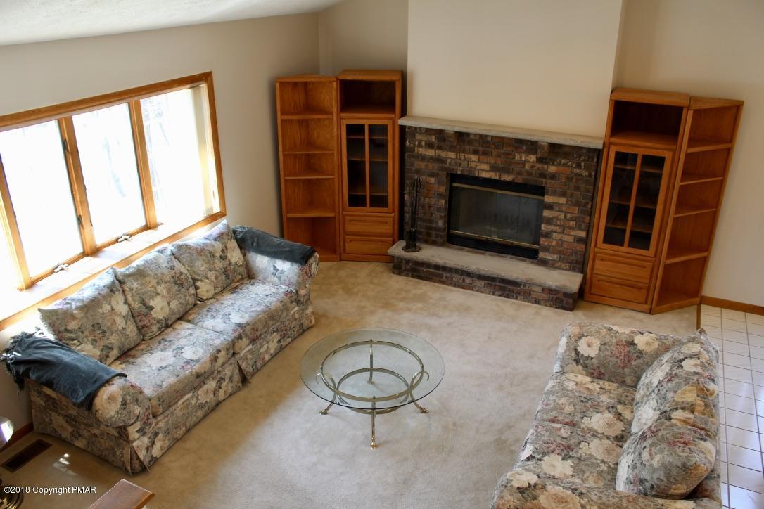108 Gold Finch Road Bushkill, PA 18324 - Photo 12 of 32 a living room with furniture a fireplace and a flat screen tv