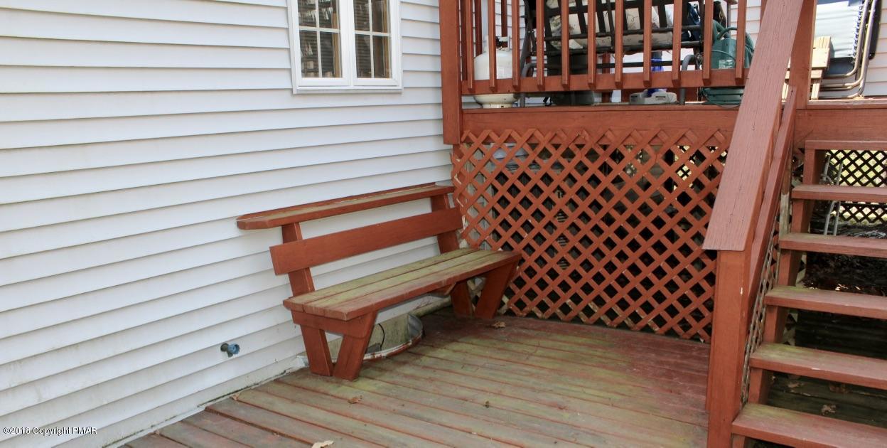 108 Gold Finch Road Bushkill, PA 18324 - Photo 26 of 32 a wooden bench sitting in front of a building