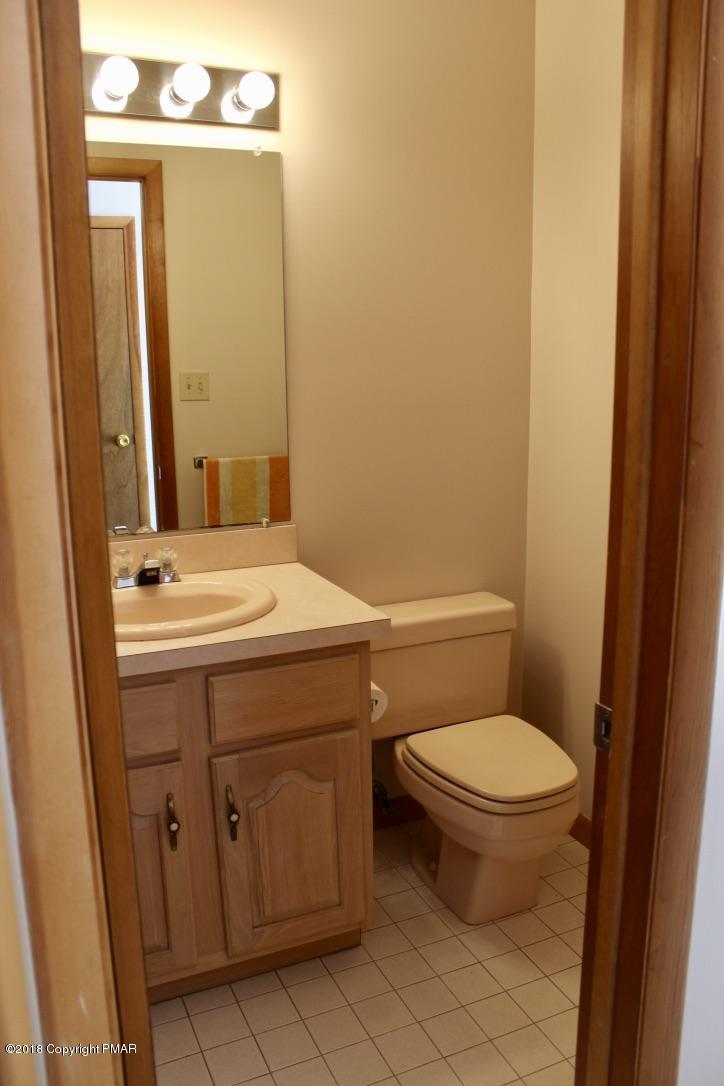 108 Gold Finch Road Bushkill, PA 18324 - Photo 32 of 32 a bathroom with a toilet a sink and a mirror