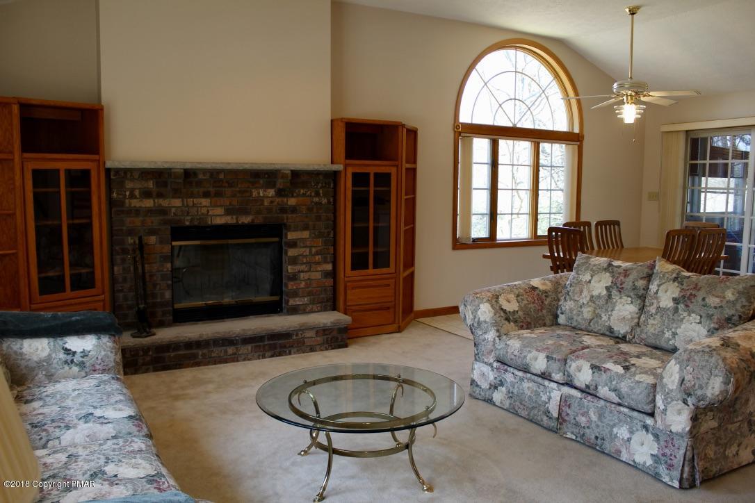 108 Gold Finch Road Bushkill, PA 18324 - Photo 10 of 32 a living room with furniture a fireplace and a large window