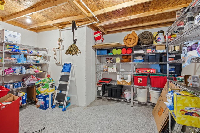 21 Pier Place Tooele, UT 84074 - Photo 65 of 112 Utility area featuring an exposed timber ceiling, white painted walls, and gray speckled flooring