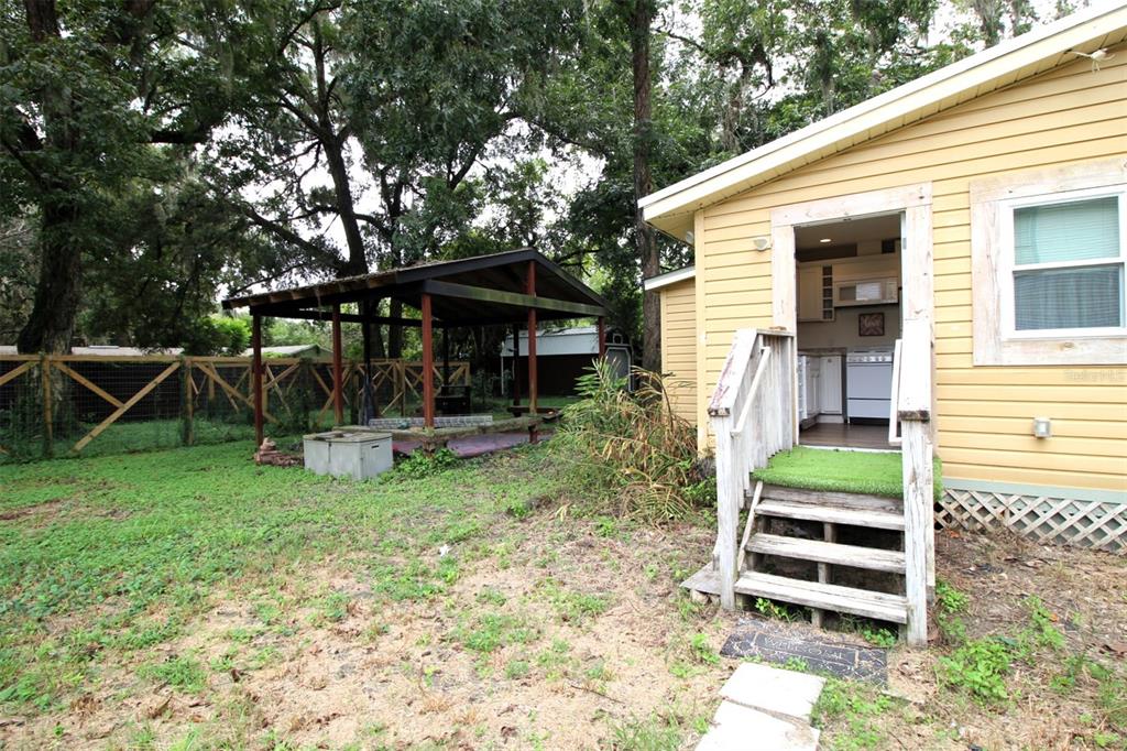 17091 Southwest 138th Lane Archer, FL 32618 - Photo 12 of 19 a view of a chair and table in backyard of the house