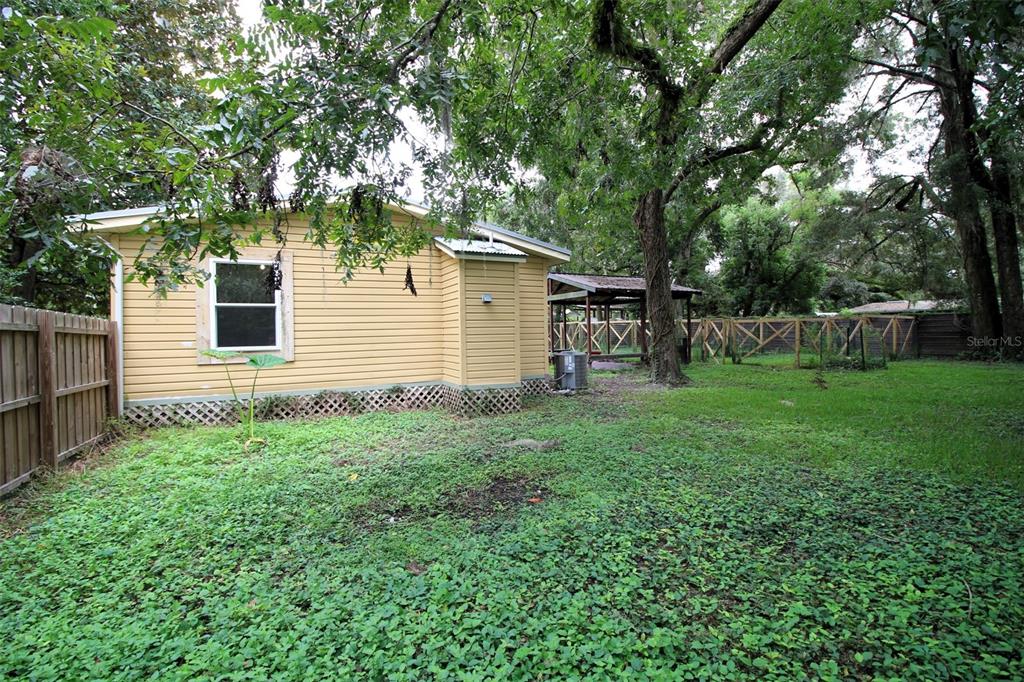17091 Southwest 138th Lane Archer, FL 32618 - Photo 18 of 19 a view of a backyard with a small cabin