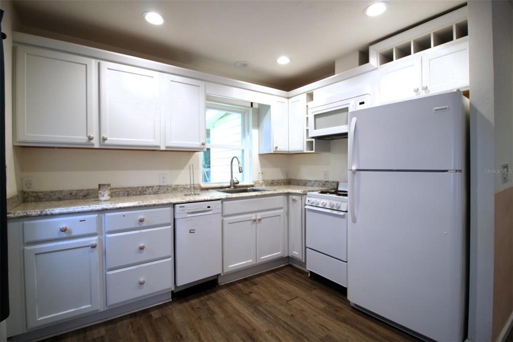 17091 Southwest 138th Lane Archer, FL 32618 - Photo 5 of 19 a kitchen with stainless steel appliances granite countertop a refrigerator sink and cabinets