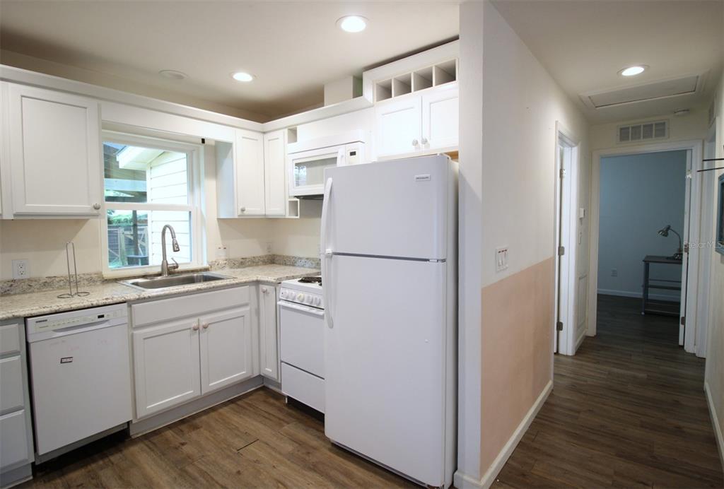 17091 Southwest 138th Lane Archer, FL 32618 - Photo 6 of 19 a kitchen with refrigerator cabinets and wooden floor