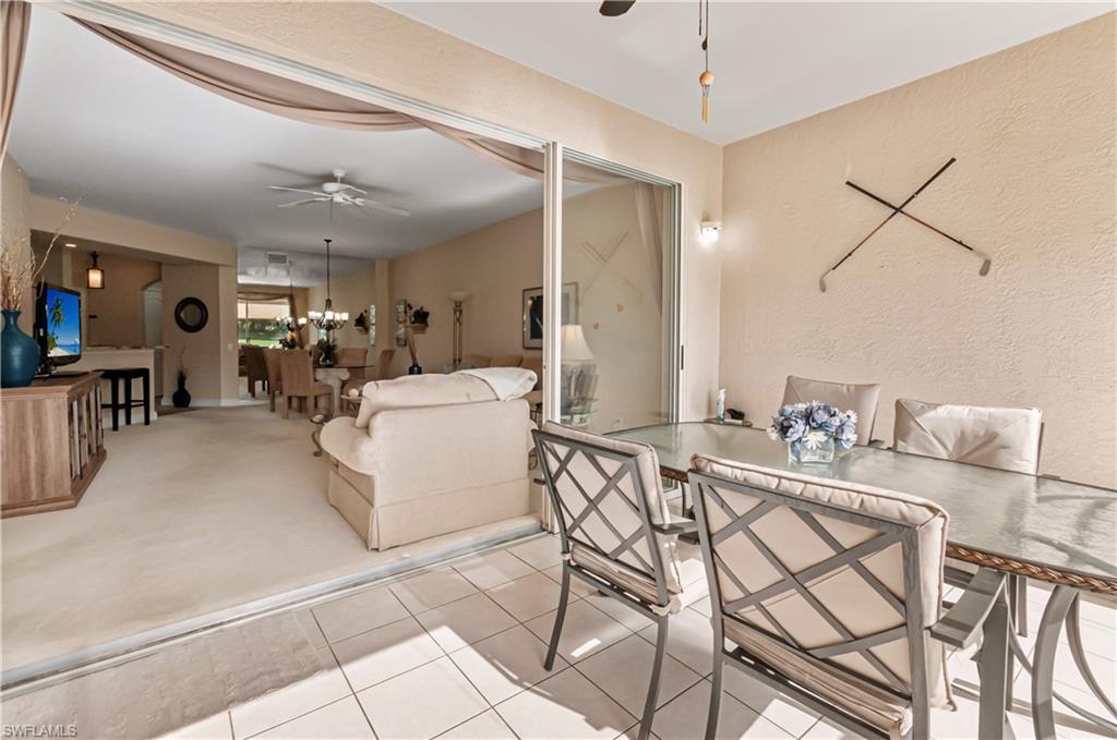 9030 Spring Run Boulevard, Unit 507 Estero, FL 34135 - Photo 13 of 21 a living room with furniture and a chandelier