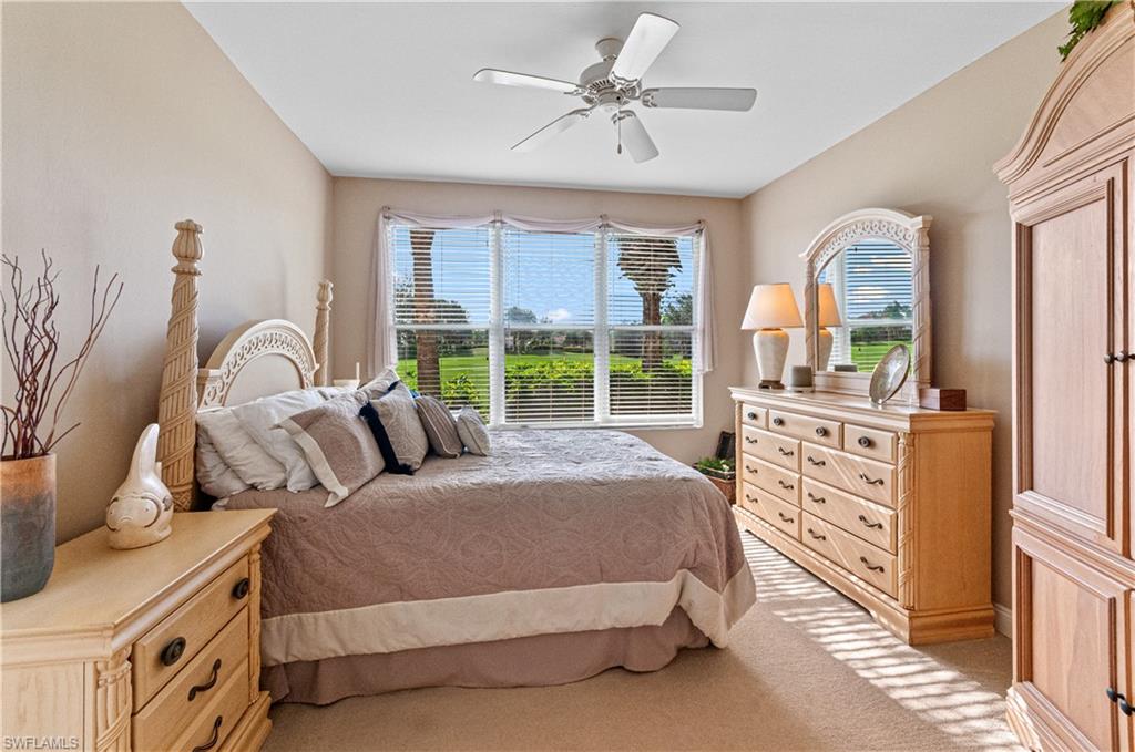 9030 Spring Run Boulevard, Unit 507 Estero, FL 34135 - Photo 14 of 21 a bedroom with a bed a dresser next to a window