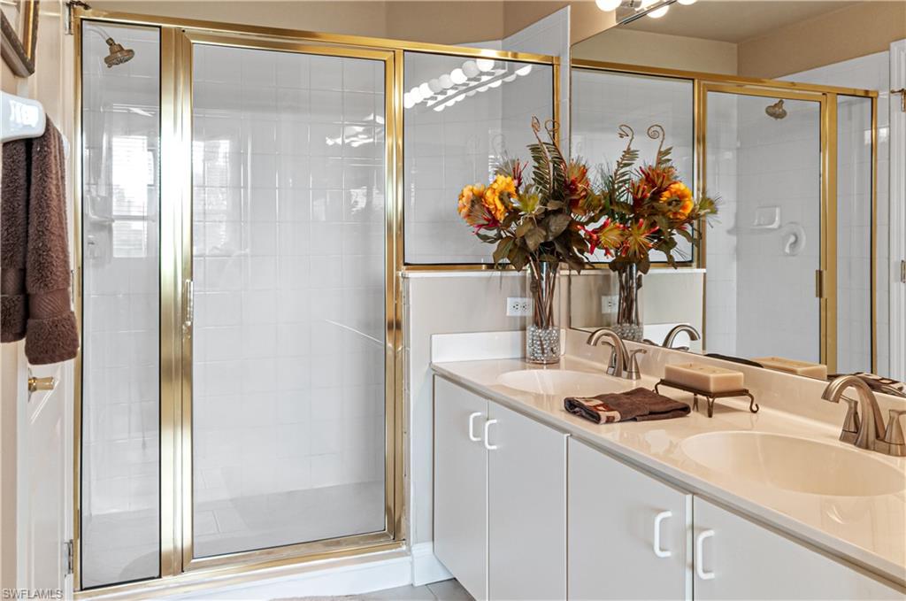9030 Spring Run Boulevard, Unit 507 Estero, FL 34135 - Photo 17 of 21 a bathroom with a sink a vanity and a mirror
