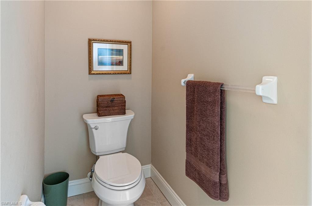 9030 Spring Run Boulevard, Unit 507 Estero, FL 34135 - Photo 18 of 21 a white toilet sitting next to a bathroom sink