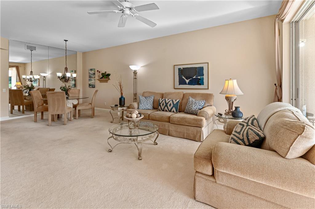9030 Spring Run Boulevard, Unit 507 Estero, FL 34135 - Photo 9 of 21 a living room with furniture and a chandelier