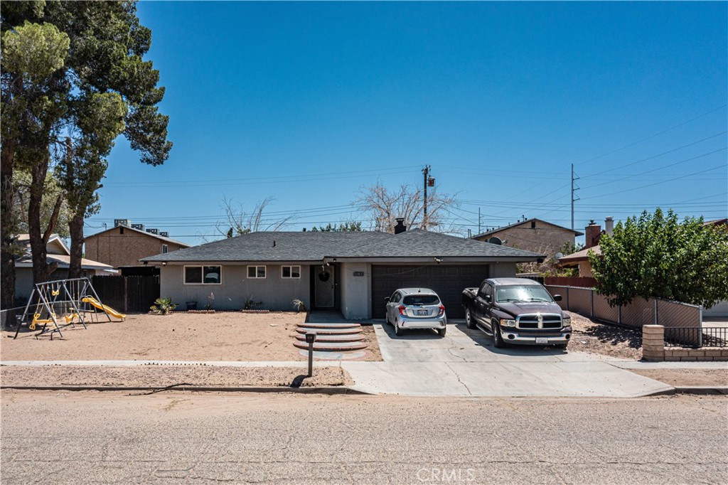 18135 Lilac Road Adelanto, CA 92301 - Photo 1 of 1 a car parked in front of a house