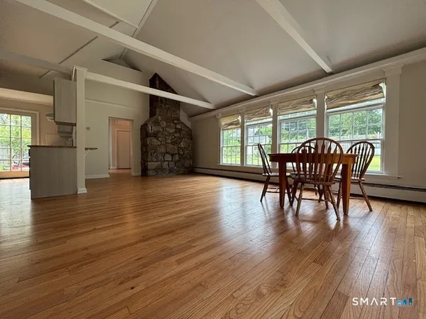 a view of a dining room with furniture window and wooden floor