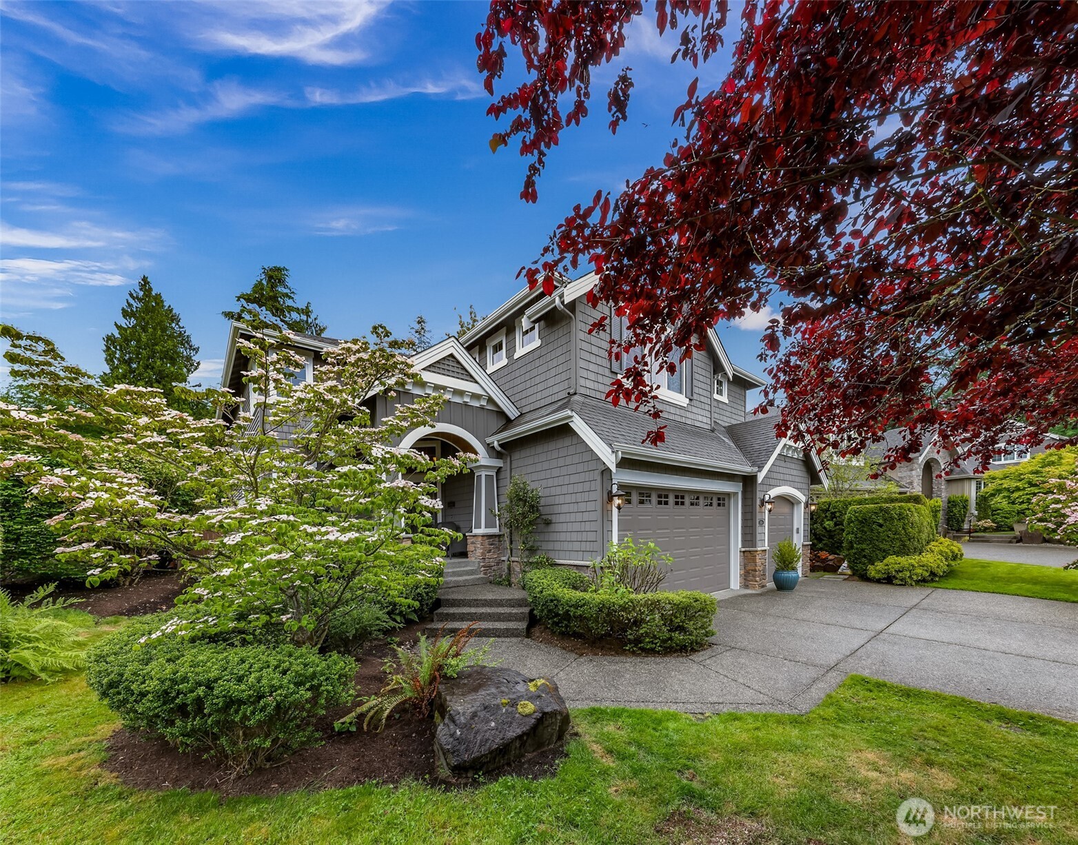 2029 240th Place Southeast Bothell, WA 98021 - Photo 2 of 39 a front view of a house with garden