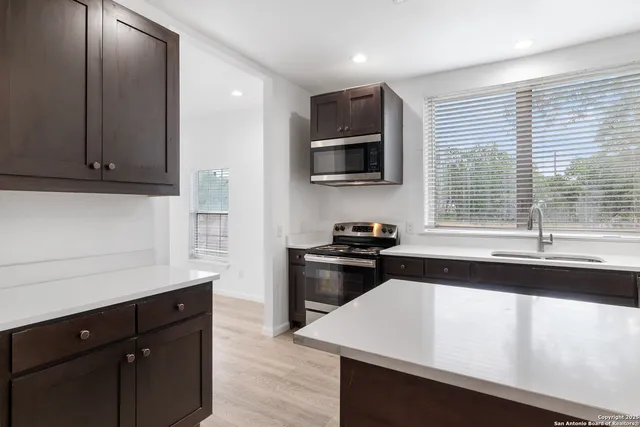 a kitchen with a sink stove and cabinets