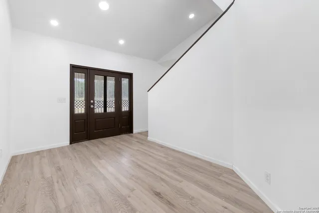 a view of a room with wooden floor