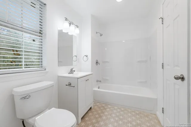 a view of a room with wooden floor and ceiling fan
