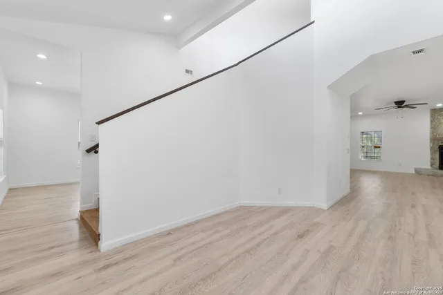 a view of a kitchen with a sink a refrigerator and microwave