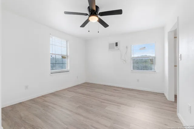 a view of empty room with wooden floor