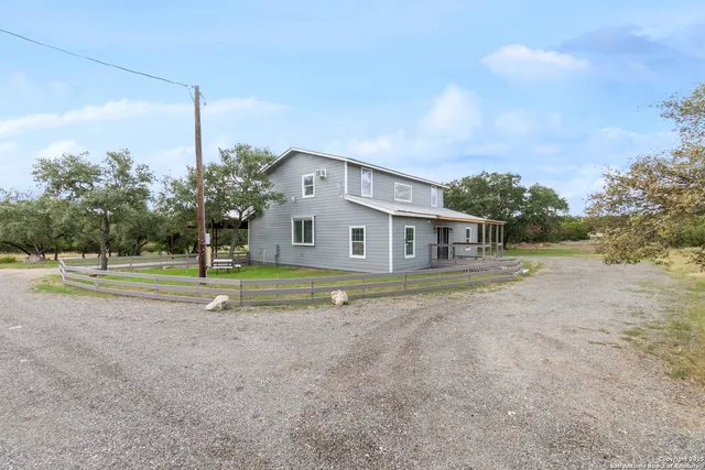 a view of a house with backyard and pool