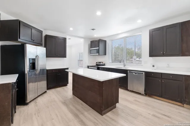 a kitchen with a refrigerator a sink and dishwasher