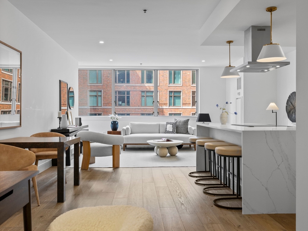 a living room with furniture a rug and white walls