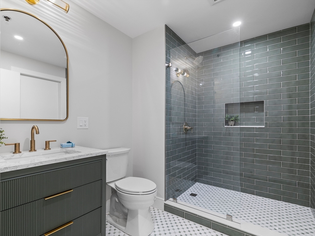 234 Causeway Street, Unit U702 Boston, MA 02114 - Photo 14 of 27 a bathroom with a sink a toilet and shower