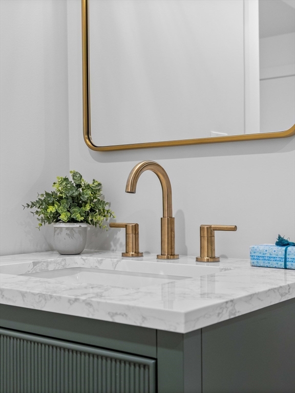 234 Causeway Street, Unit U702 Boston, MA 02114 - Photo 16 of 27 a bathroom with a sink and a mirror