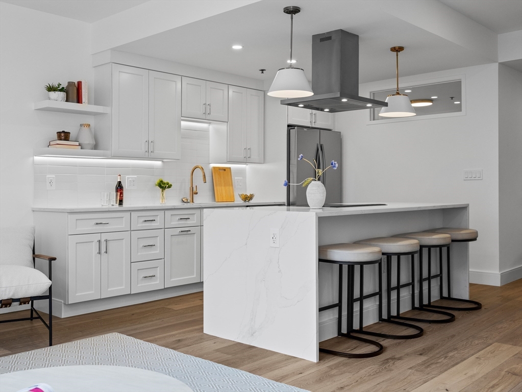 234 Causeway Street, Unit U702 Boston, MA 02114 - Photo 2 of 27 a kitchen with a sink stainless steel appliances and cabinets