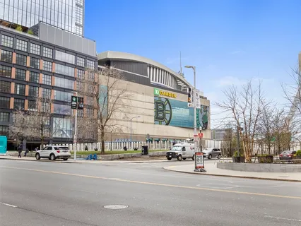 a city street with tall buildings and a street sign