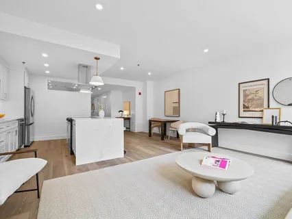 a living room with kitchen island furniture and a dining table with wooden floor