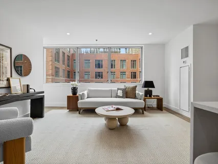 a living room with furniture a rug and a large window