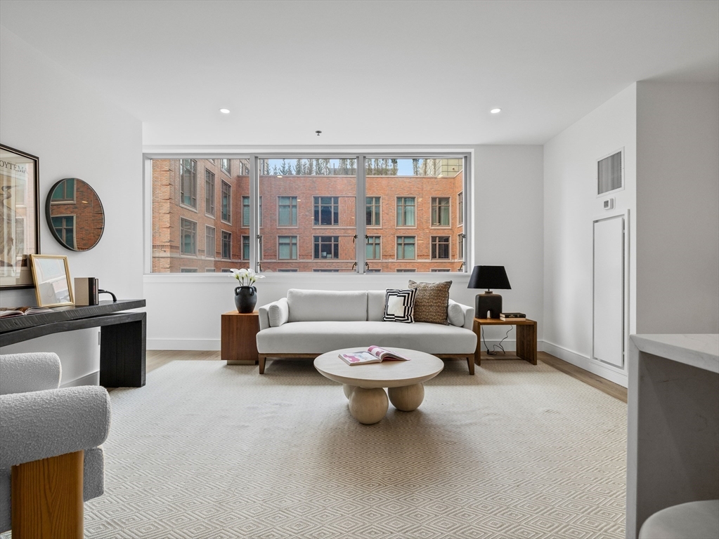 234 Causeway Street, Unit U702 Boston, MA 02114 - Photo 5 of 27 a living room with furniture a rug and a large window