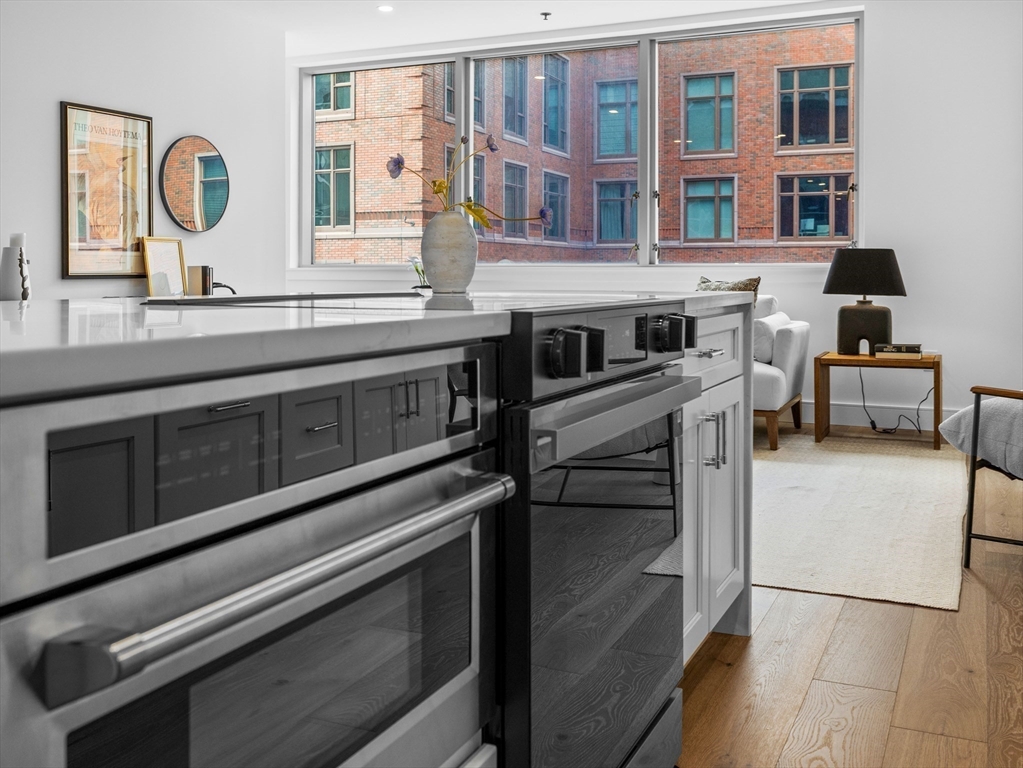234 Causeway Street, Unit U702 Boston, MA 02114 - Photo 9 of 27 a kitchen with a stove and a microwave