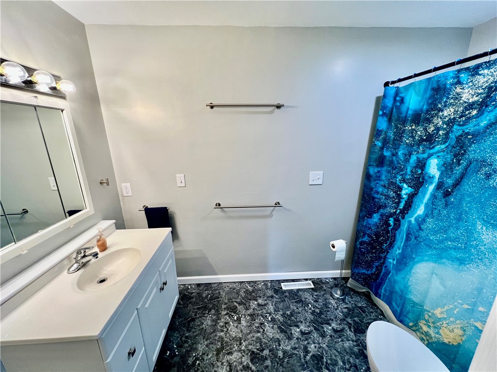 1272 South Lake Ridge Avenue Decatur, IL 62521 - Photo 17 of 20 a bathroom with a sink and a mirror