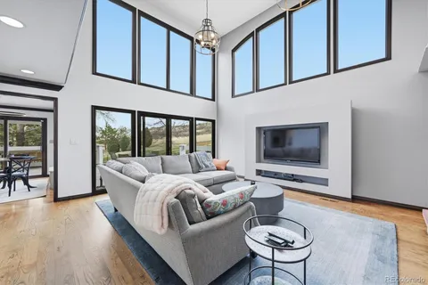 a view of a balcony with chairs and wooden floor