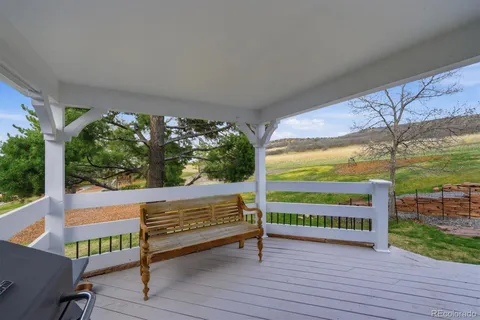 a view of a chairs and table on the wooden deck