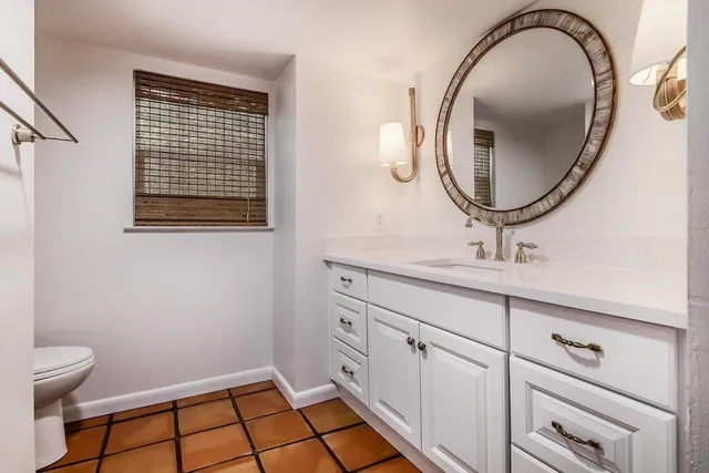 a bathroom with a sink a vanity and a mirror