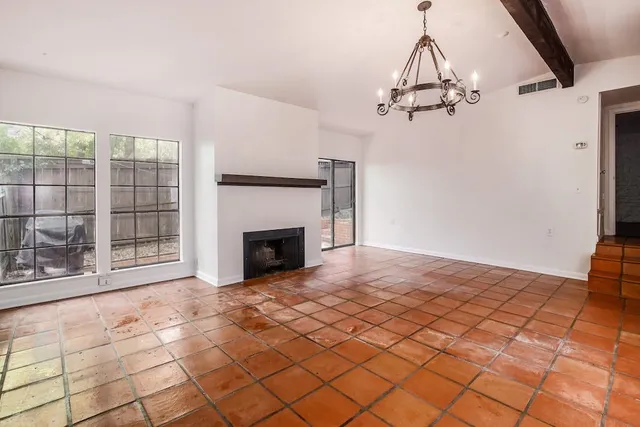 a view of a livingroom with a fireplace and cabinet