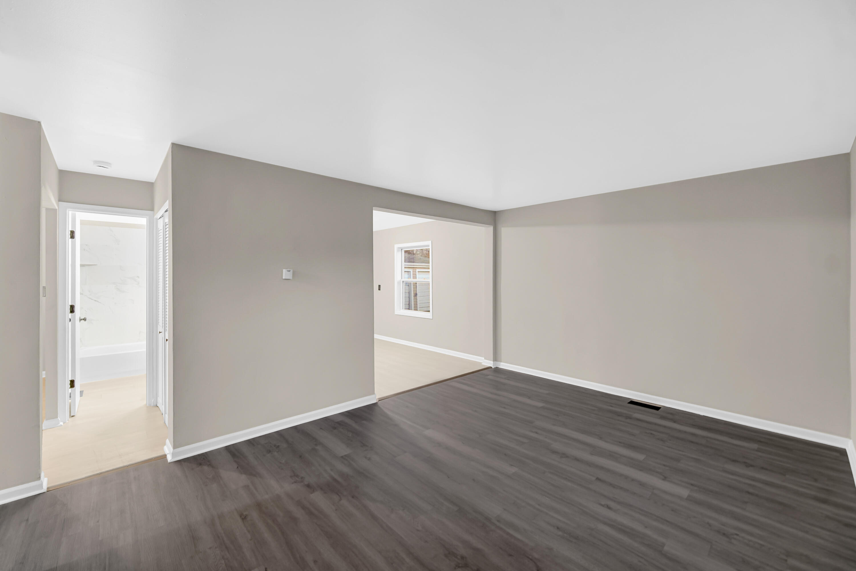 625 South Wells Street Gary, IN 46403 - Photo 11 of 18 a view of an empty room with wooden floor and a window