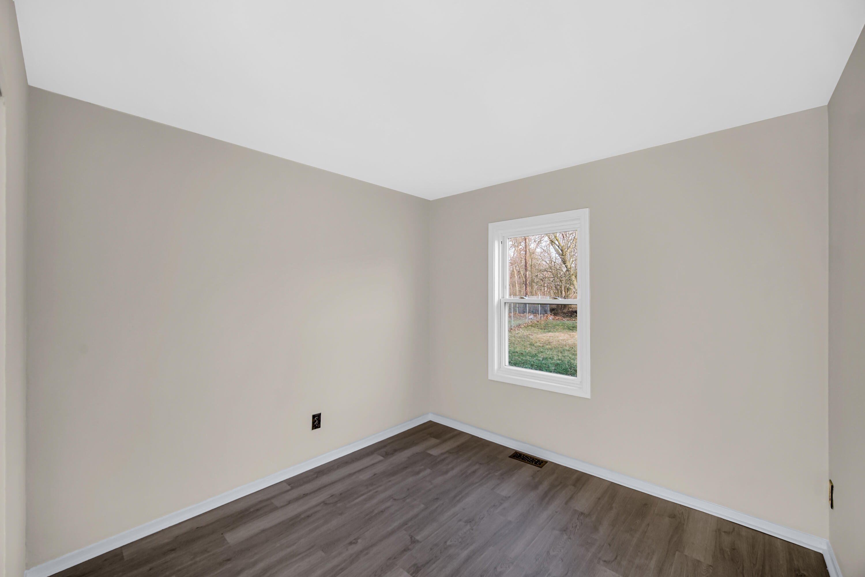 625 South Wells Street Gary, IN 46403 - Photo 12 of 18 an empty room with wooden floor and windows