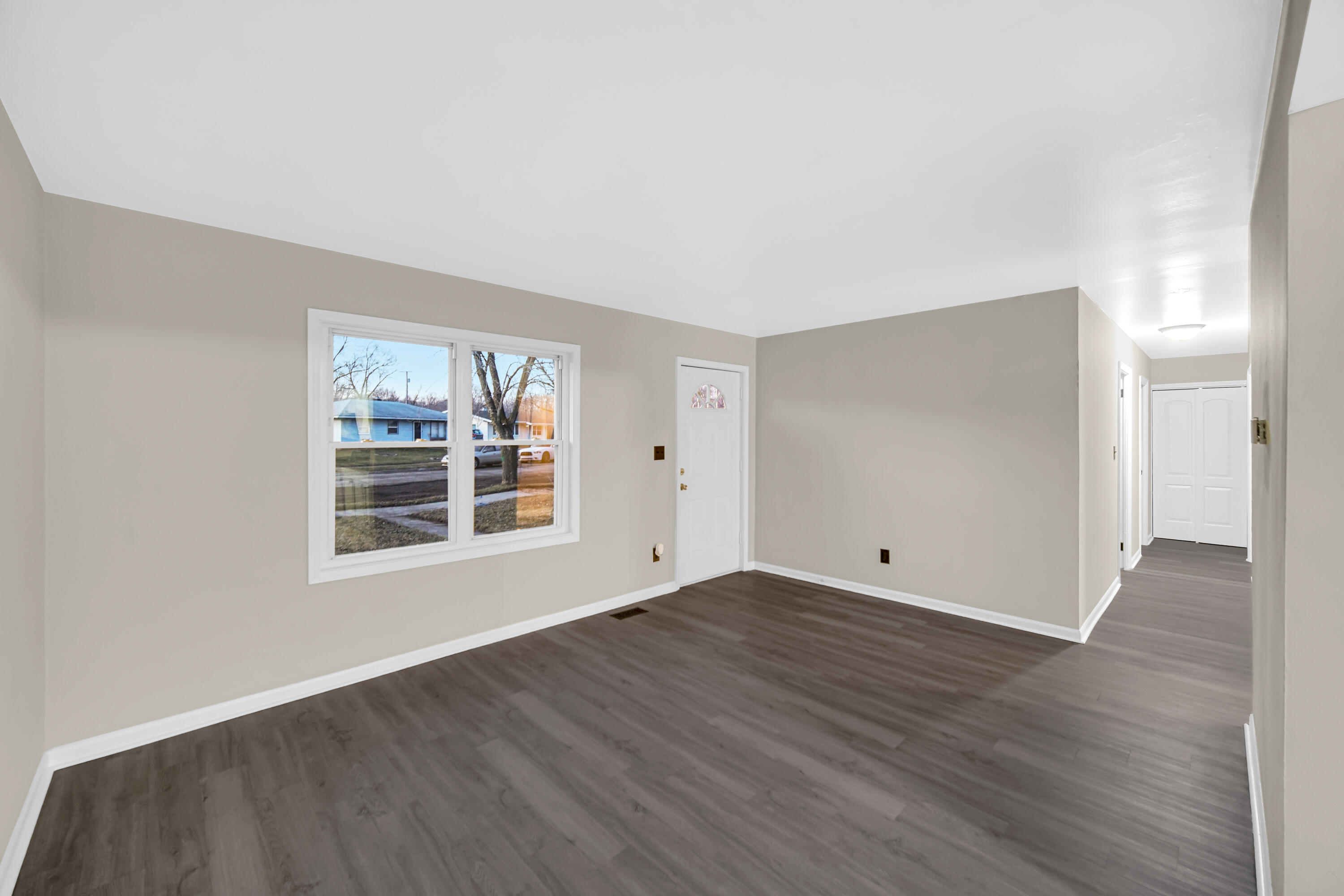 625 South Wells Street Gary, IN 46403 - Photo 5 of 18 an empty room with wooden floor and windows