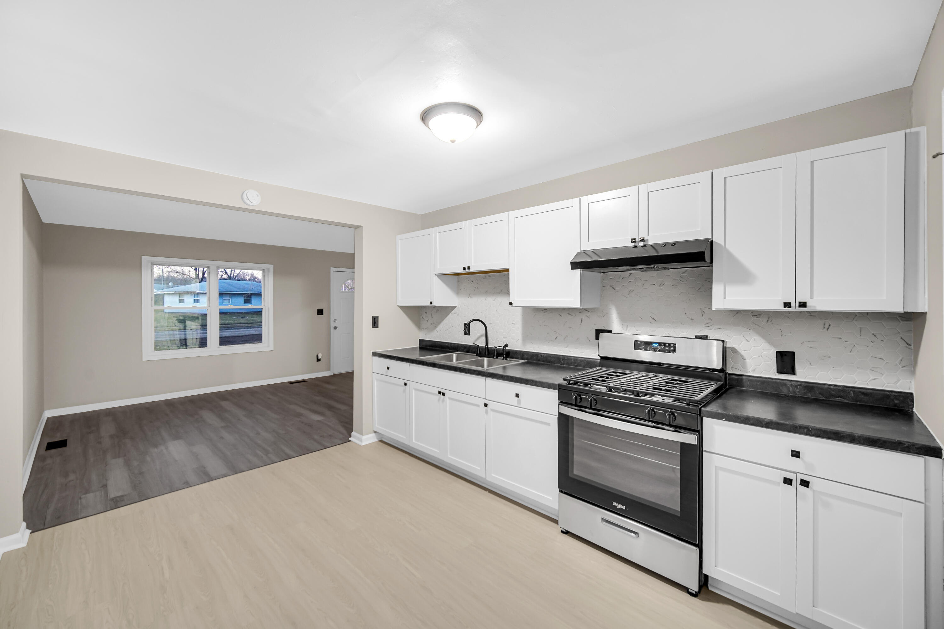 625 South Wells Street Gary, IN 46403 - Photo 8 of 18 a kitchen with stainless steel appliances granite countertop a stove and a sink