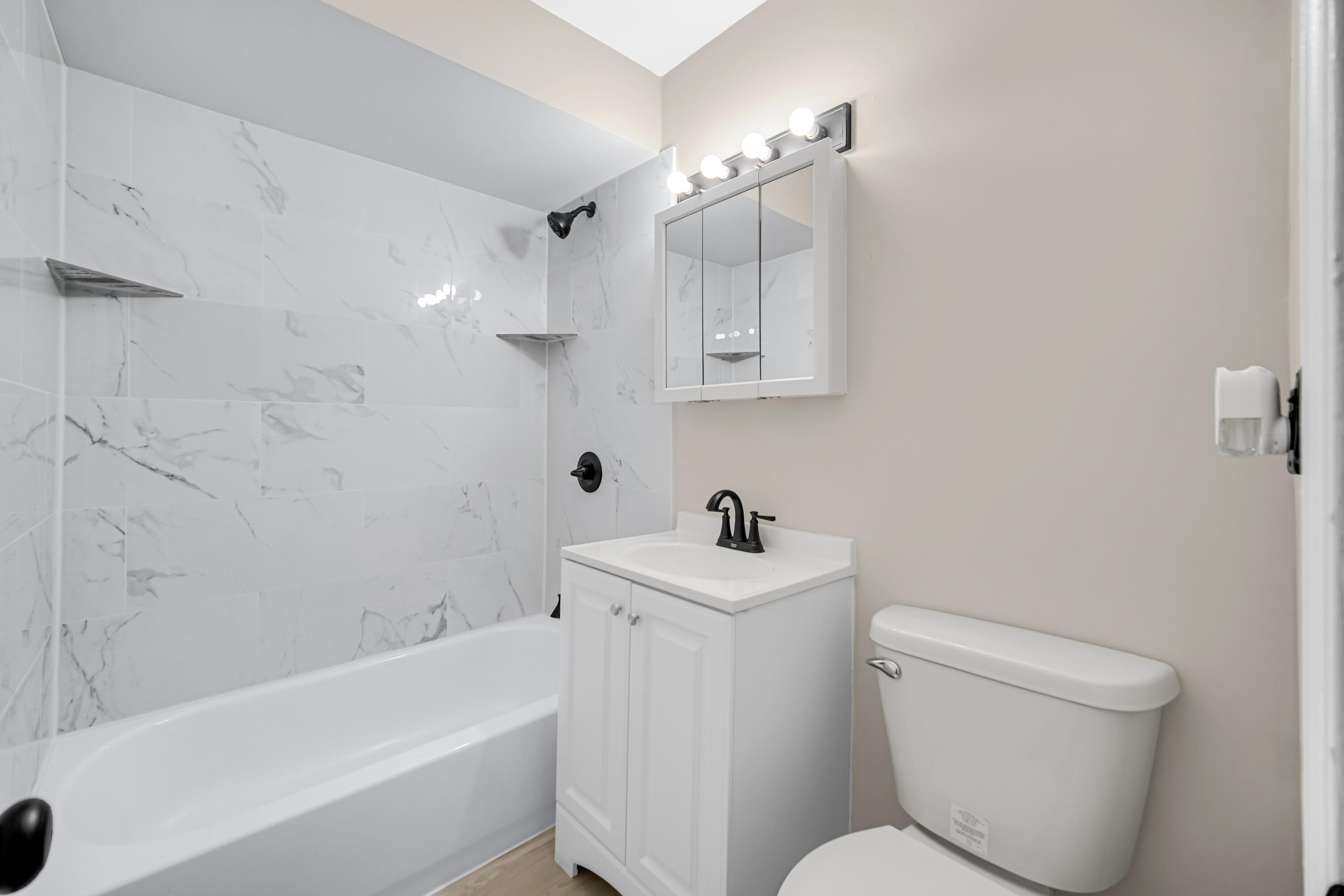 625 South Wells Street Gary, IN 46403 - Photo 10 of 18 a white toilet sitting next to a bath tub