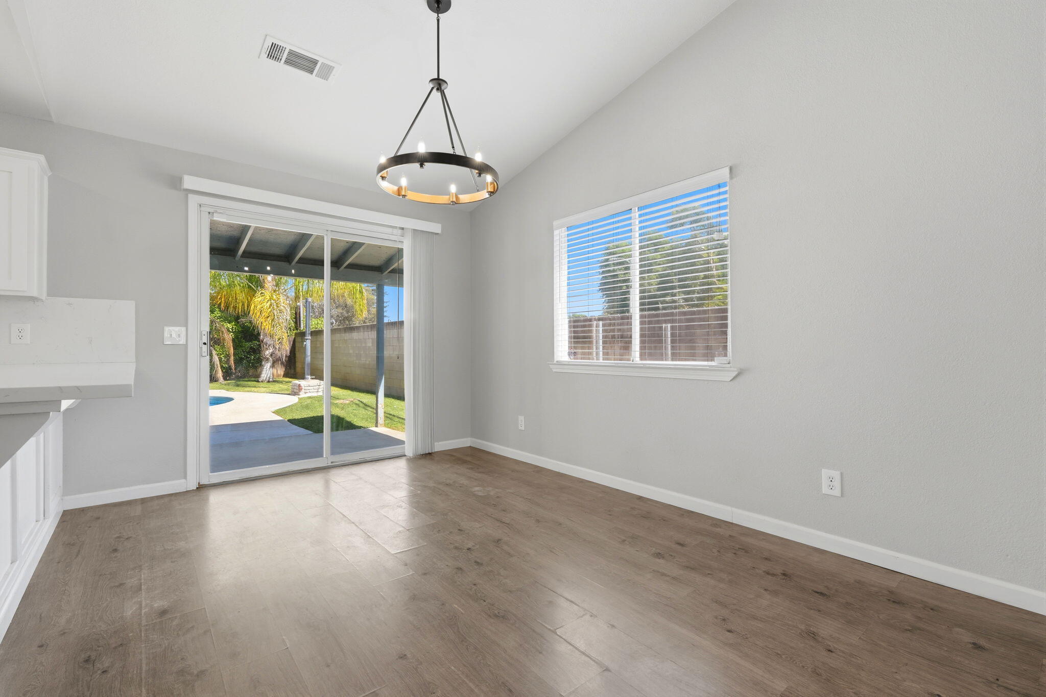 481 Katelyn Court Exeter, CA 93221 - Photo 23 of 33 a view of an empty room with a window and wooden floor